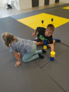 Children playing with topple tubes