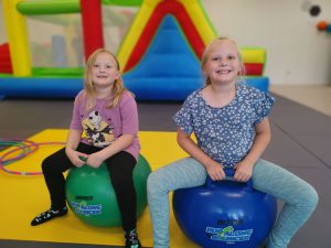 Children playing on hopper balls