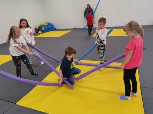 children play with pool noodles